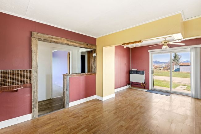 Empty room featuring wood finished floors, crown molding, and heating unit | Image 23