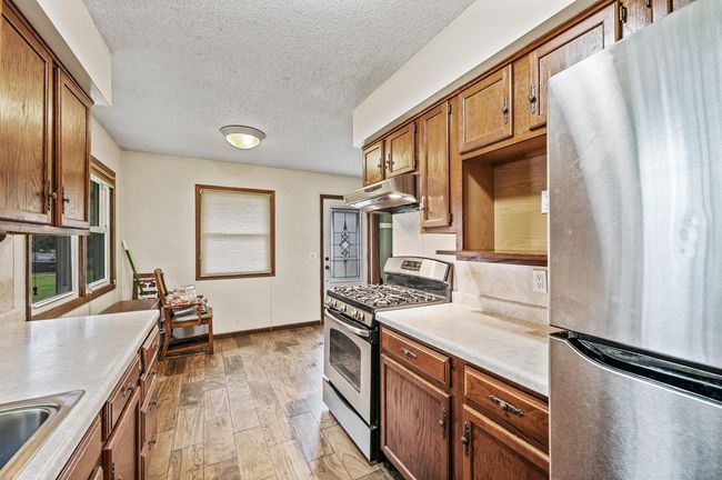 Kitchen eat-in space where the chairs are. | Image 8
