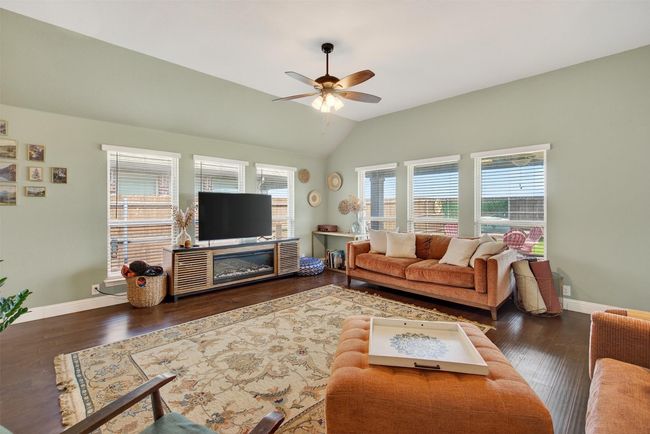 Living area featuring lofted ceiling, ceiling fan, and wood finished floors | Image 20
