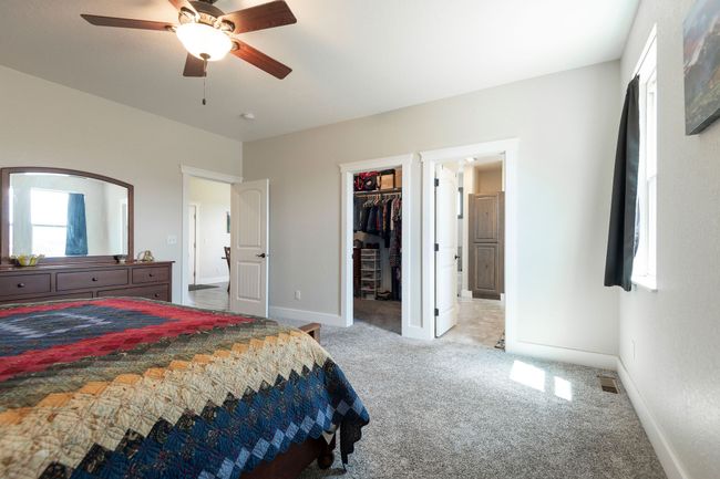 Carpeted bedroom with a spacious closet, ceiling fan, and a closet | Image 13