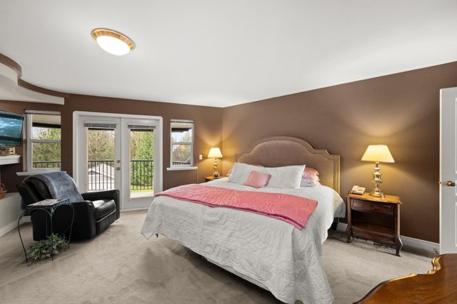Bedroom with french doors, multiple windows, light carpet, and access to exterior | Image 25