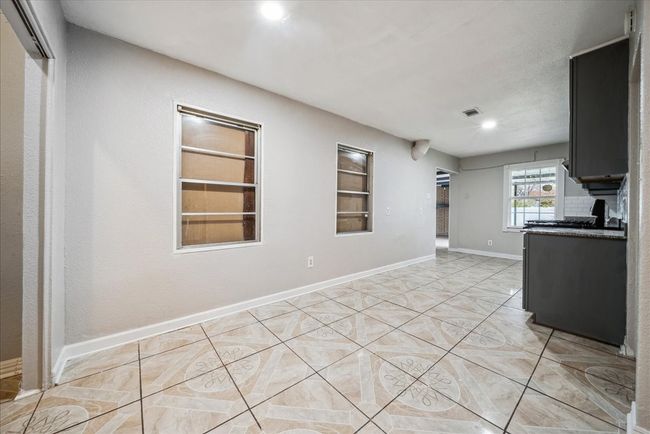 Kitchen with built in shelves, light tile patterned floors, and recessed lighting | Image 8