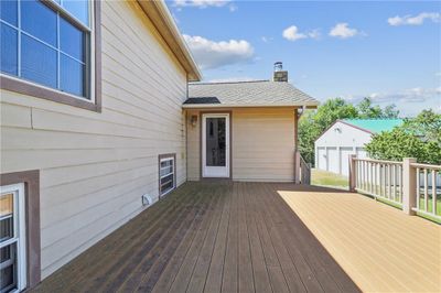 Wooden deck featuring a garage and an outbuilding | Image 3