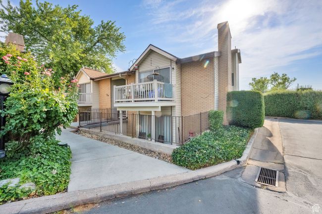 View of front of property with brick siding, a chimney, and a balcony | Image 15