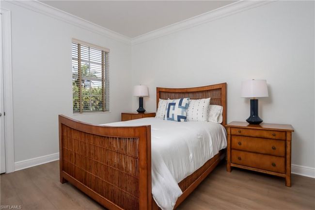 Bedroom with wood finished floors and ornamental molding | Image 20