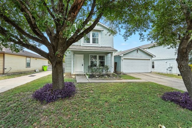 View of front of house featuring driveway, covered porch, a front yard, and a garage | Image 4