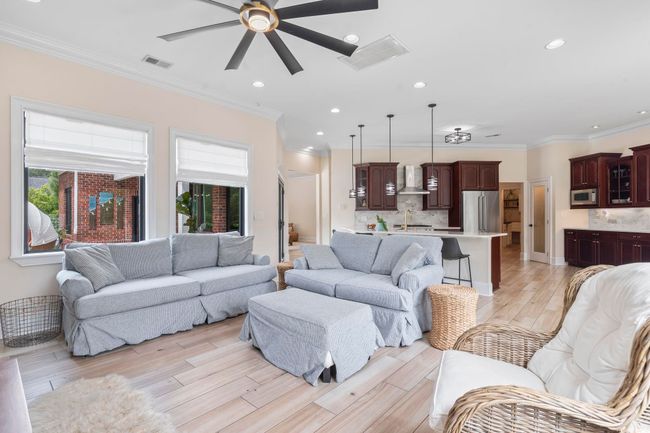 Living room featuring ceiling fan, recessed lighting, light wood-style flooring, and crown molding | Image 15