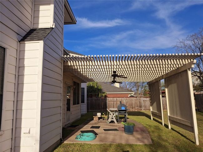 View of patio with a pergola and fence | Image 4