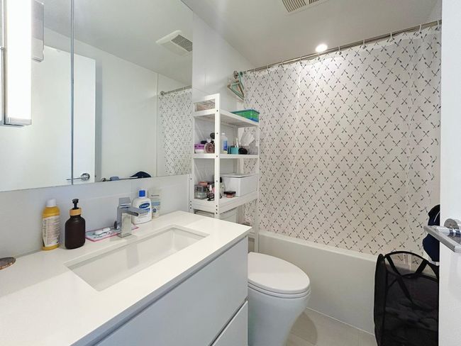 Bathroom with vanity, toilet, shower / tub combo, and tile patterned floors | Image 10