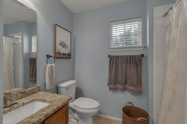 Full bathroom with vanity, tile patterned flooring, and a shower with shower curtain | Image 25