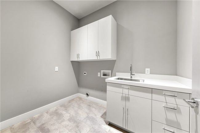 Laundry room with hookup for an electric dryer, washer hookup, and cabinet space | Image 27