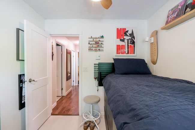 Bedroom with wood finished floors, a textured ceiling, and ceiling fan | Image 20
