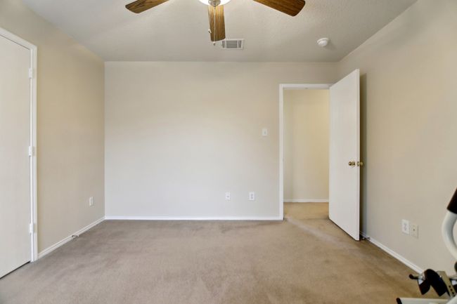 Unfurnished bedroom with carpet, baseboards, ceiling fan, and visible vents | Image 30