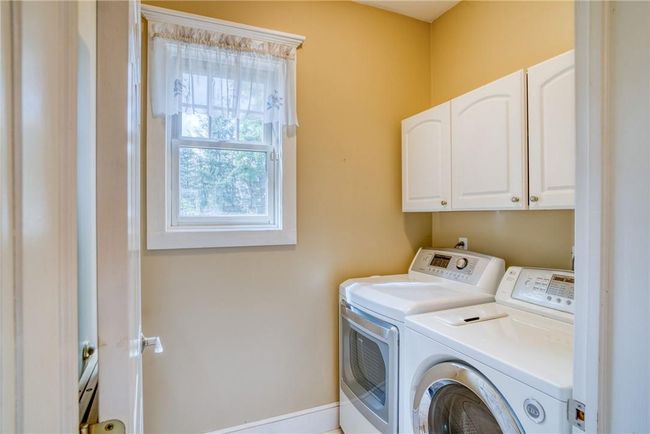 Laundry room with cabinets and washing machine and clothes dryer | Image 18
