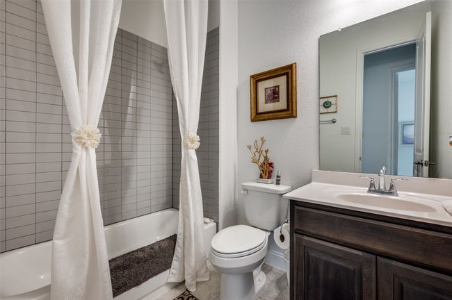 Guest bathroom with tile surround tub. | Image 15