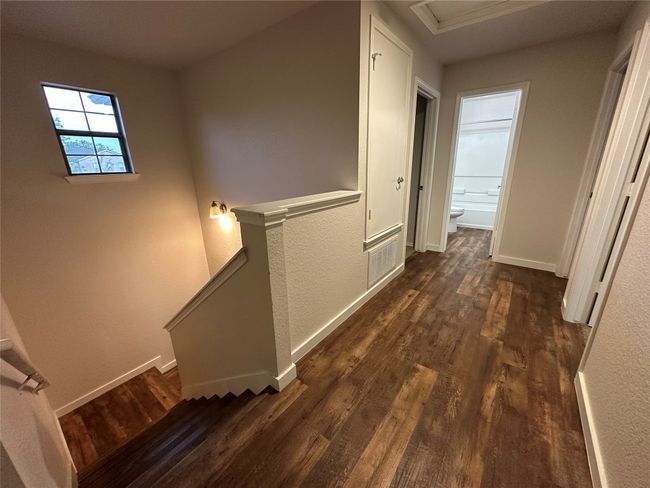 Hallway featuring an upstairs landing and dark wood finished floors | Image 36
