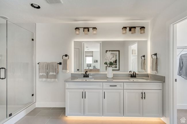 Full bathroom with double vanity, a stall shower, and tile patterned flooring | Image 6
