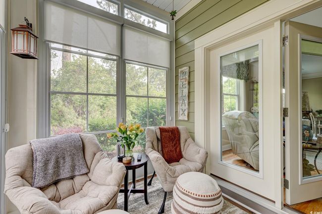 Living room featuring wood finished floors, visible vents, and baseboards | Image 14