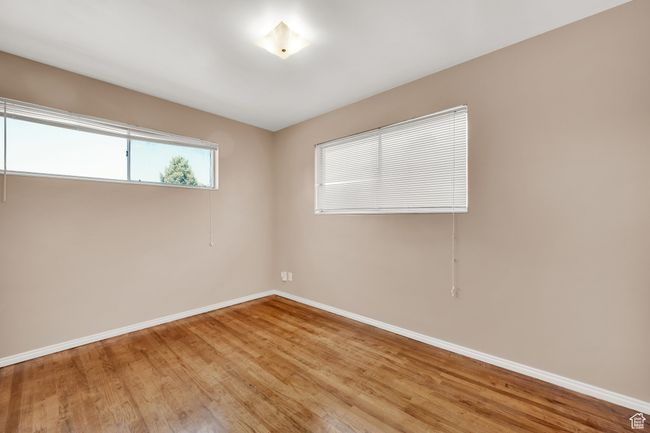 Unfurnished room featuring baseboards and light wood finished floors | Image 13