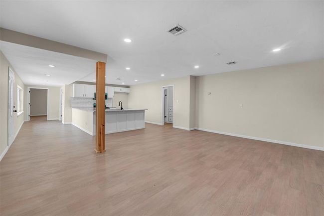 Basement featuring sink and light hardwood / wood-style flooring | Image 12