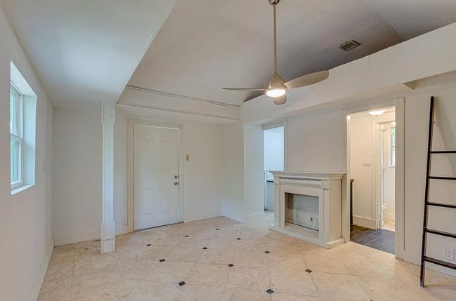 Unfurnished living room featuring ceiling fan, a fireplace, and tile patterned floors | Image 20