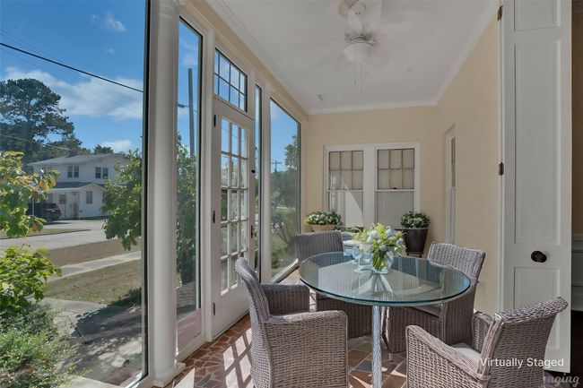 Sunroom featuring crown molding and brick floors | Image 14