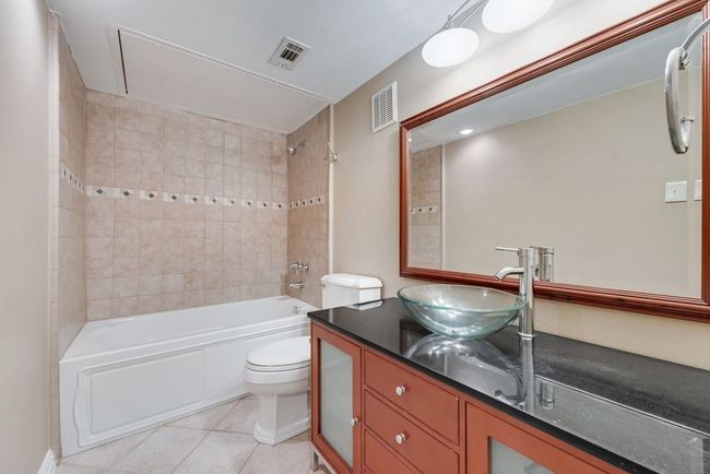 Full bathroom with visible vents, toilet, bathtub / shower combination, and tile patterned floors | Image 16