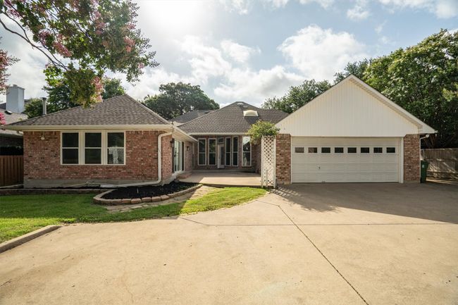 A view of the back of the main house showing the large drive way and the back patio. | Image 32