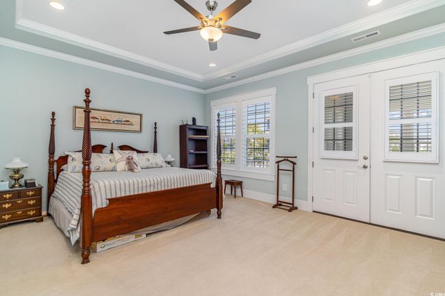 Bedroom with light carpet, crown molding, visible vents, and baseboards | Image 18