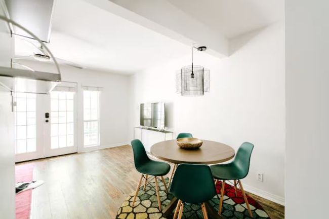 Dining room with baseboards and wood finished floors | Image 7