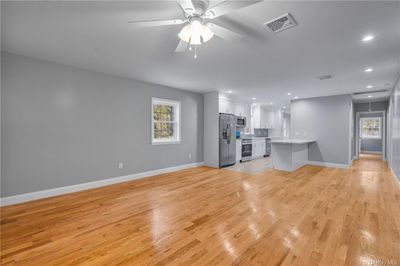 Unfurnished living room featuring light wood-type flooring and ceiling fan | Image 3