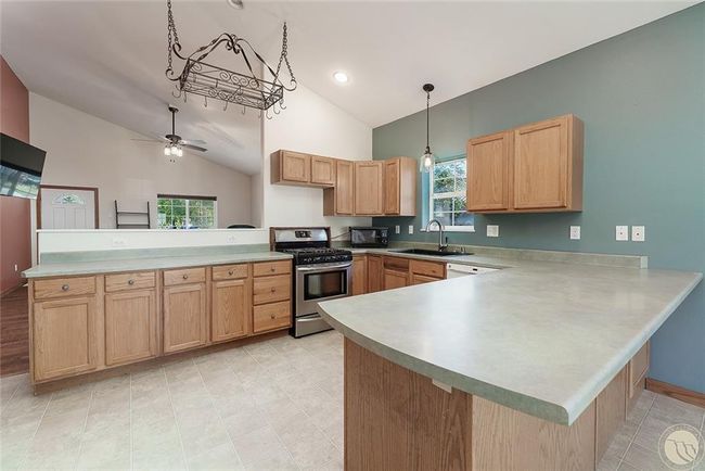 Kitchen, bar and looking towards living room area. | Image 6