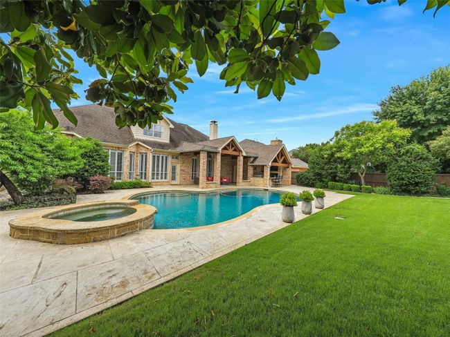 View of swimming pool featuring a patio and a pool with connected hot tub | Image 39