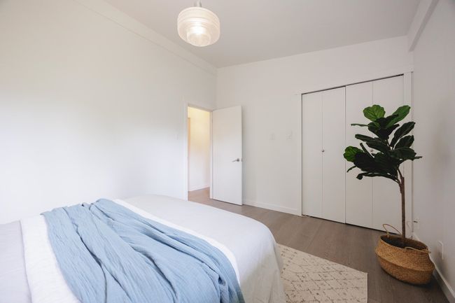 Bedroom with wood finished floors and a closet | Image 18