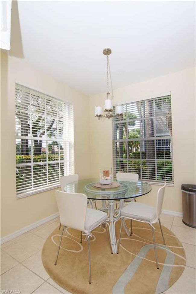 Enjoy a light meal or get caught up on your email at the glass dining table that is flanked by two oversized windows. | Image 16