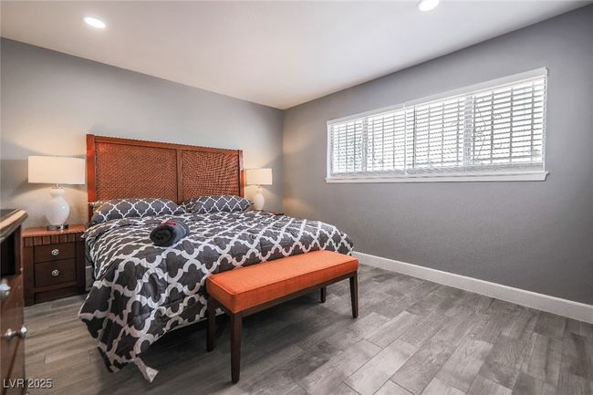Bedroom featuring baseboards, light wood-type flooring, and recessed lighting | Image 41