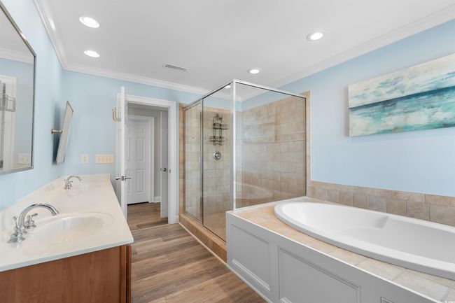 Primary En-Suite Full bathroom featuring a tile shower, garden jetted tub, and double vanity | Image 27