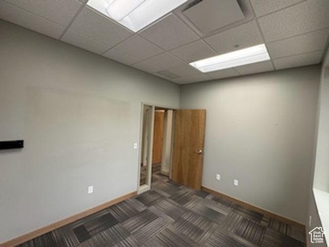 Carpeted empty room with a paneled ceiling | Image 34