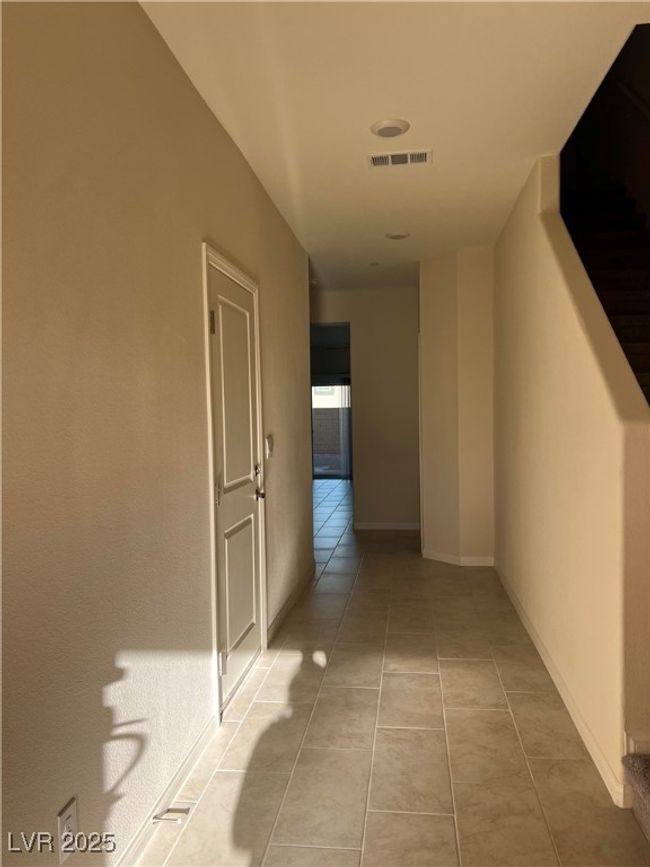 Hall featuring light tile patterned floors and baseboards | Image 4