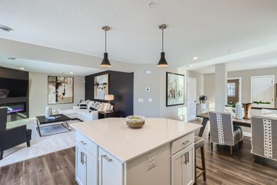 (Photo of decorated model, actual home's finishes may vary slightly) Enjoy plenty of seating at the kitchen island and dining area adjacent to the kitchen. Perfect for entertaining or having a family meal together. | Image 3