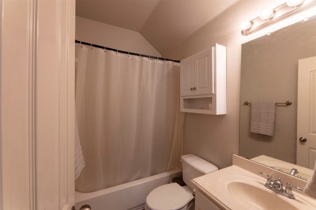 Full bathroom with vaulted ceiling, vanity, and shower / bathtub combination with curtain | Image 34