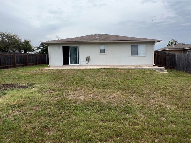 Rear exterior. Notice full gutters and large concrete patio | Image 22