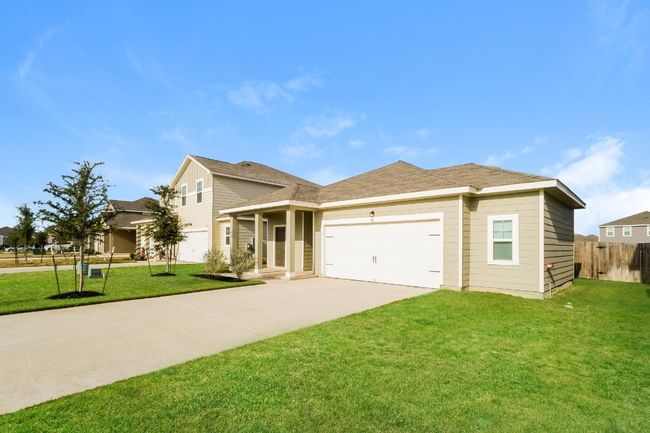 Traditional-style home with driveway and an attached garage | Image 4