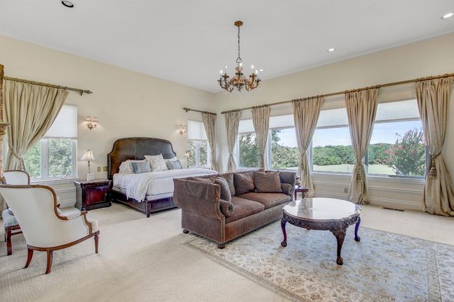 Carpeted bedroom with a chandelier and recessed lighting | Image 19