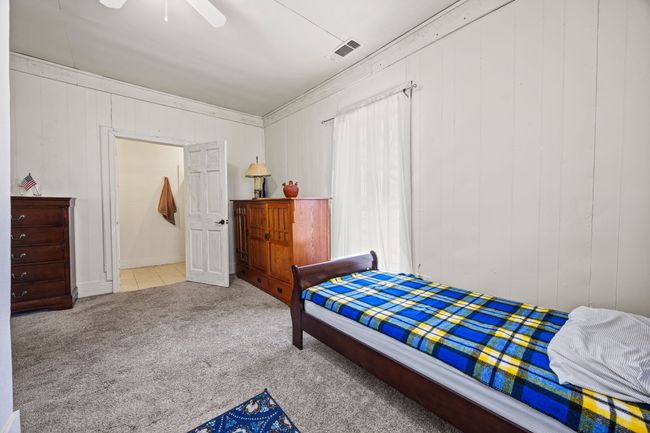 Carpeted bedroom with visible vents and a ceiling fan | Image 21