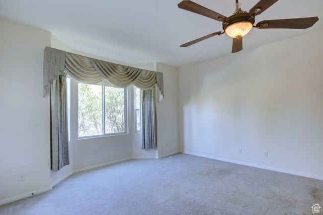 Carpeted empty room with baseboards and ceiling fan | Image 9