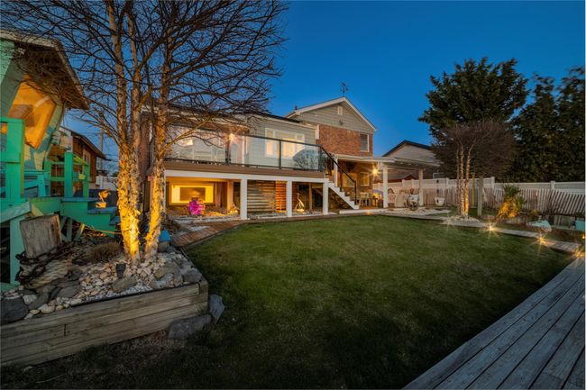 View of yard featuring a fenced backyard, stairway, a deck, and a patio area | Image 41
