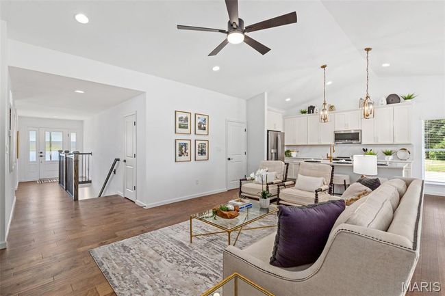 Living room with ceiling fan, dark wood-style flooring, recessed lighting, vaulted ceiling, and baseboards | Image 11
