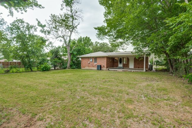 View of large back yard with central AC unit and a patio | Image 25