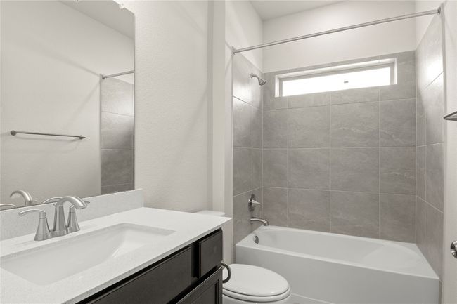 Bathroom with vanity and bathing tub / shower combination | Image 26